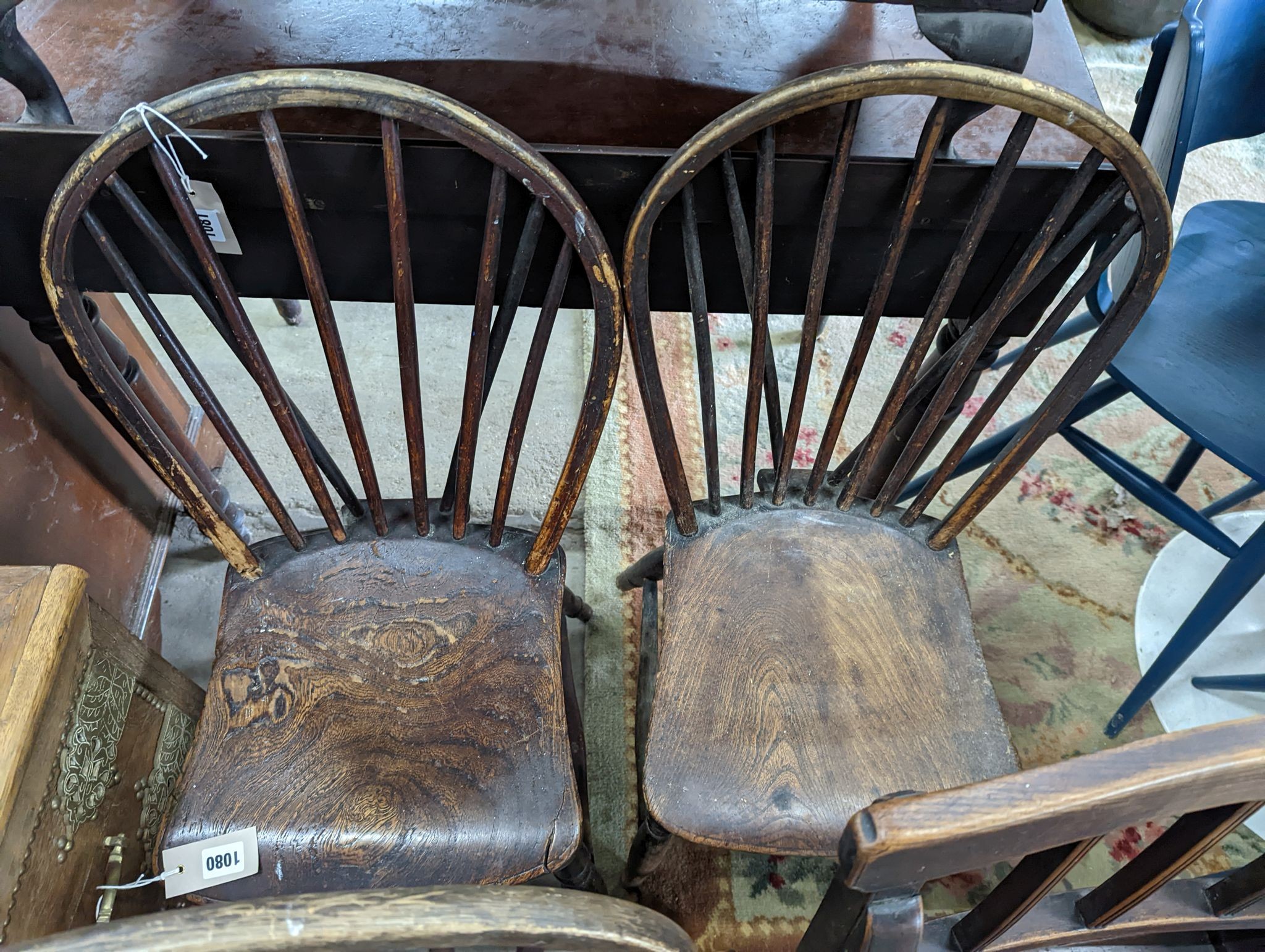 A 19th century elm and ash primitive Windsor comb back chair with traces of original paint, two other Windsor comb back chairs, a George III provincial elbow chair and an oval mahogany tea tray